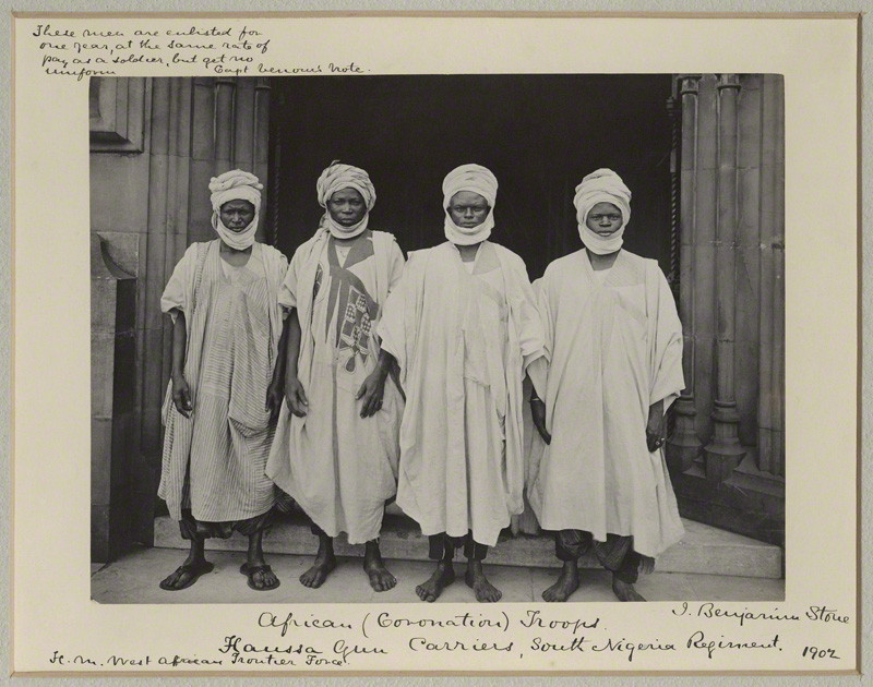 NPG x125431; Four Hausa Gun Carriers of the South Nigerian Regiment by Sir (John) Benjamin Stone