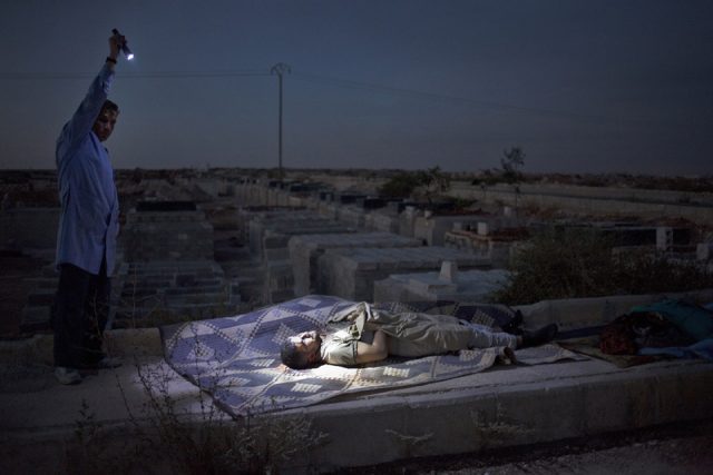 A Free Syrian Army fighter illuminating the body of an unknown man, killed by Syrian Army artillery shelling, in the cementery of Aleppo, Syria, 13 October 2012, before burying it in a common grave. As casualties mount, Aleppo's few operating hospitals struggle to cope with the number of victims, mostly civilians, caused by several months of fighting between the government's forces and Syrian rebels. 13 October 2012 EPA/MAYSUN A Free Syrian Army fighter illuminating the body of an unknown man, killed by Syrian Army artillery shelling, in the cementery of Aleppo, Syria, 13 October 2012, before burying it in a common grave. As casualties mount, Aleppo's few operating hospitals struggle to cope with the number of victims, mostly civilians, caused by several months of fighting between the government's forces and Syrian rebels. 13 October 2012 EPA/MAYSUN