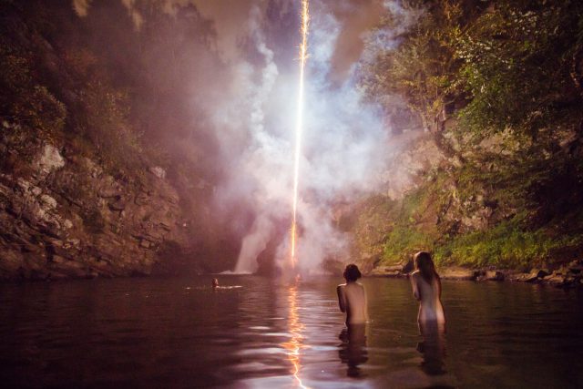 Amanda and Alli watch friends set off fireworks at a waterfall during a camping trip, 2013. © Bryan Derballa Amanda and Alli watch friends set off fireworks at a waterfall during a camping trip, 2013. © Bryan Derballa