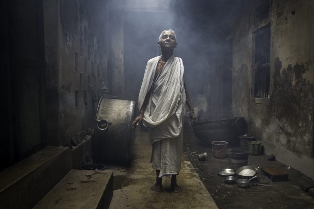 NABADWIP, WEST BENGAL, INDIA - APRIL 05, 2016: Bhakti Dashi, 75 years old from Bangladesh, says she has been living in Nabadwip Bhajanashram ashram since Bangladesh Independence around 25 years ago. Bhakti lives in the back area of the ashram, behind the temple with a few other widows. During they day other widows come to the ashram to pray and chant in exchange for food. — © Amy Toensing