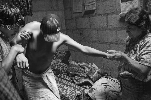 Pedro Mendoza attempting to walk after a healing with the aid of his mother and a friend.© Fran Antmann Pedro Mendoza attempting to walk after a healing with the aid of his mother and a friend.© Fran Antmann